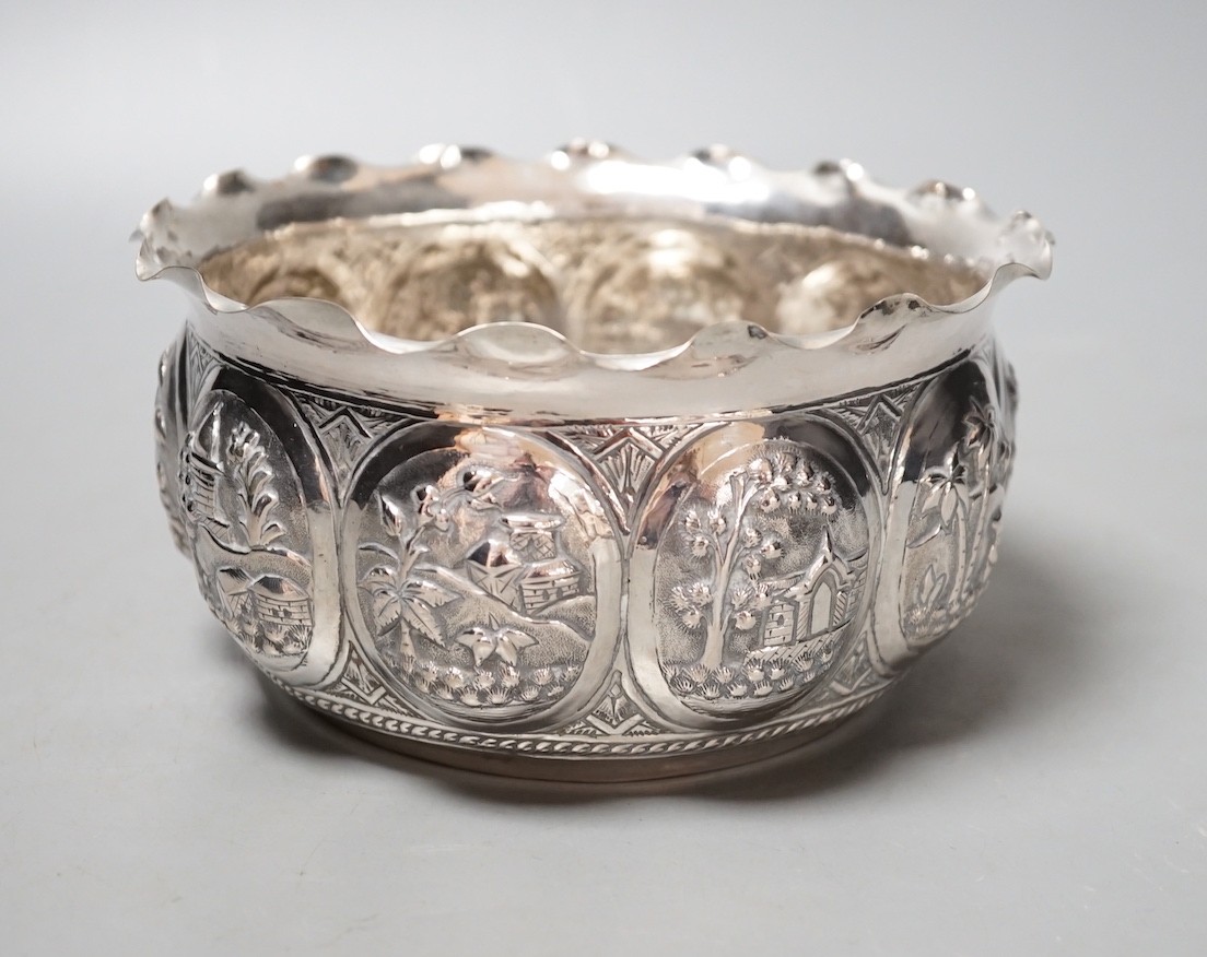 An Indian embossed white metal bowl, decorated with various scenes, diameter 16.5cm, 9oz.